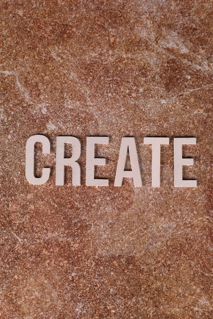The word CREATE displayed on a brown textured background inspires creativity and motivation.